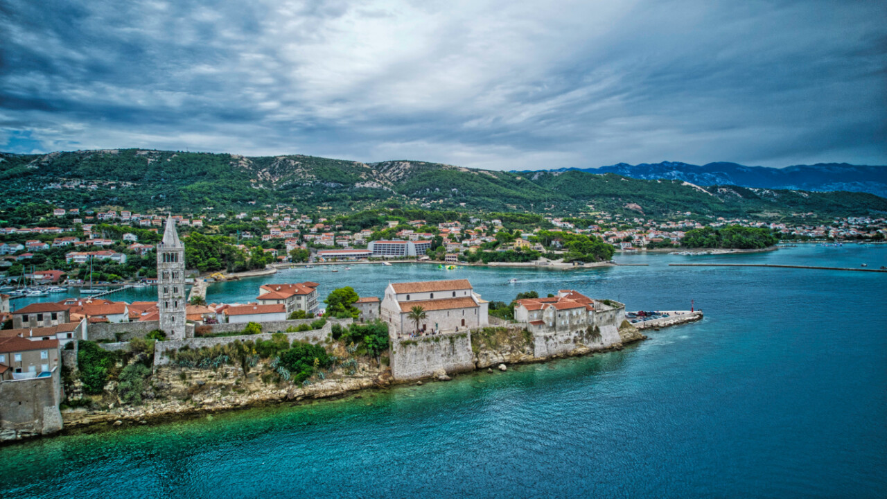 Rab stands out for its historic old town, sandy beaches, and calmer sailing environment.